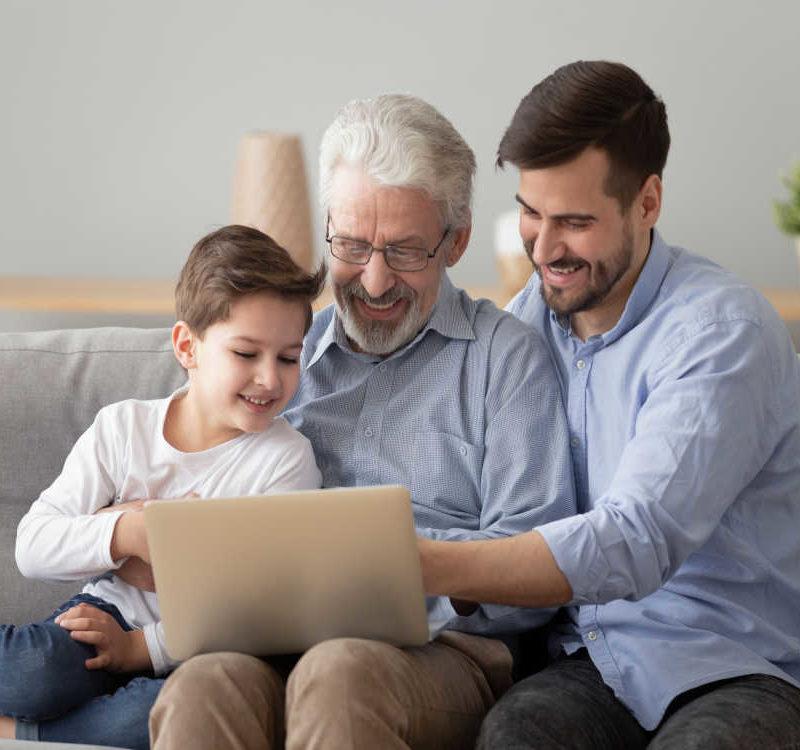 Grandpa Grown Son Small Preschool Grandson Looking At Laptop Together