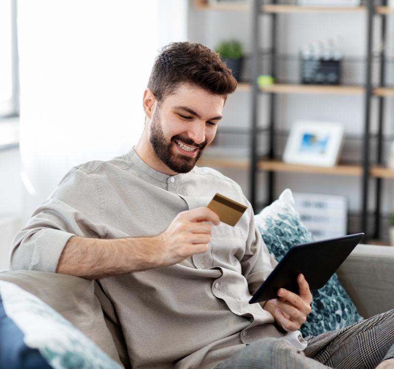 Technology, People And Online Shopping Concept Happy Smiling Man With Tablet Pc Computer And Credit Card At Home