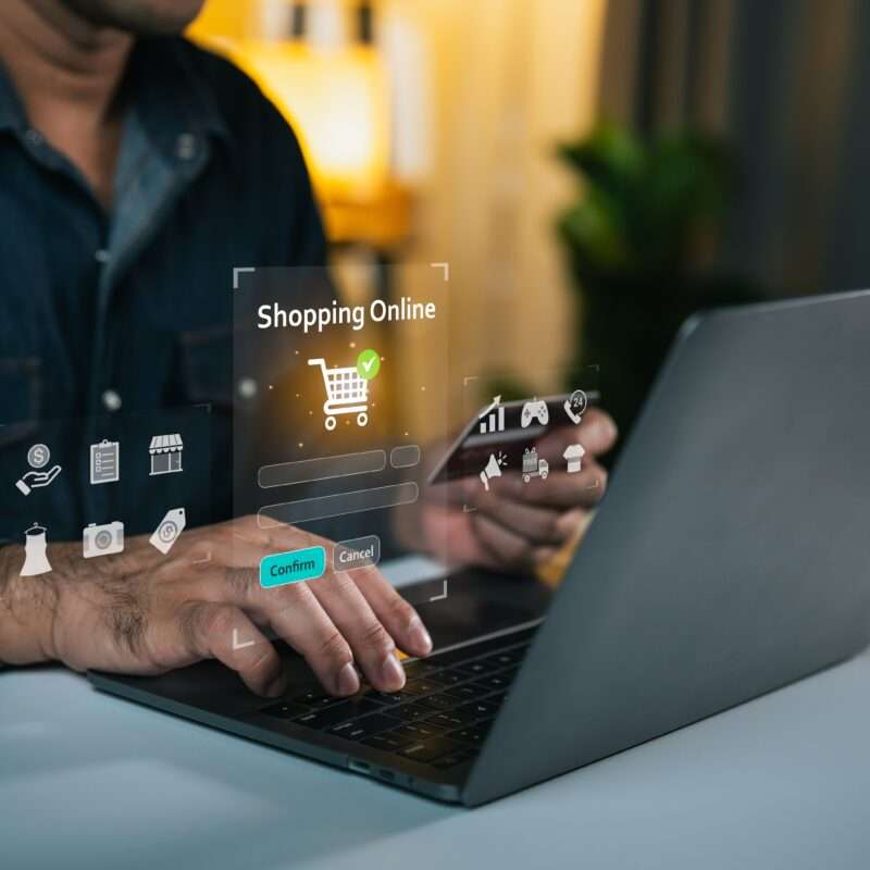 Person,using,laptop,for,online,shopping,with,digital,interface,showing
